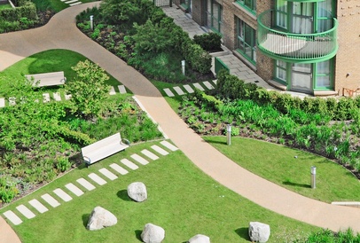 An aerial view of a landscaped courtyard garden with a curving path